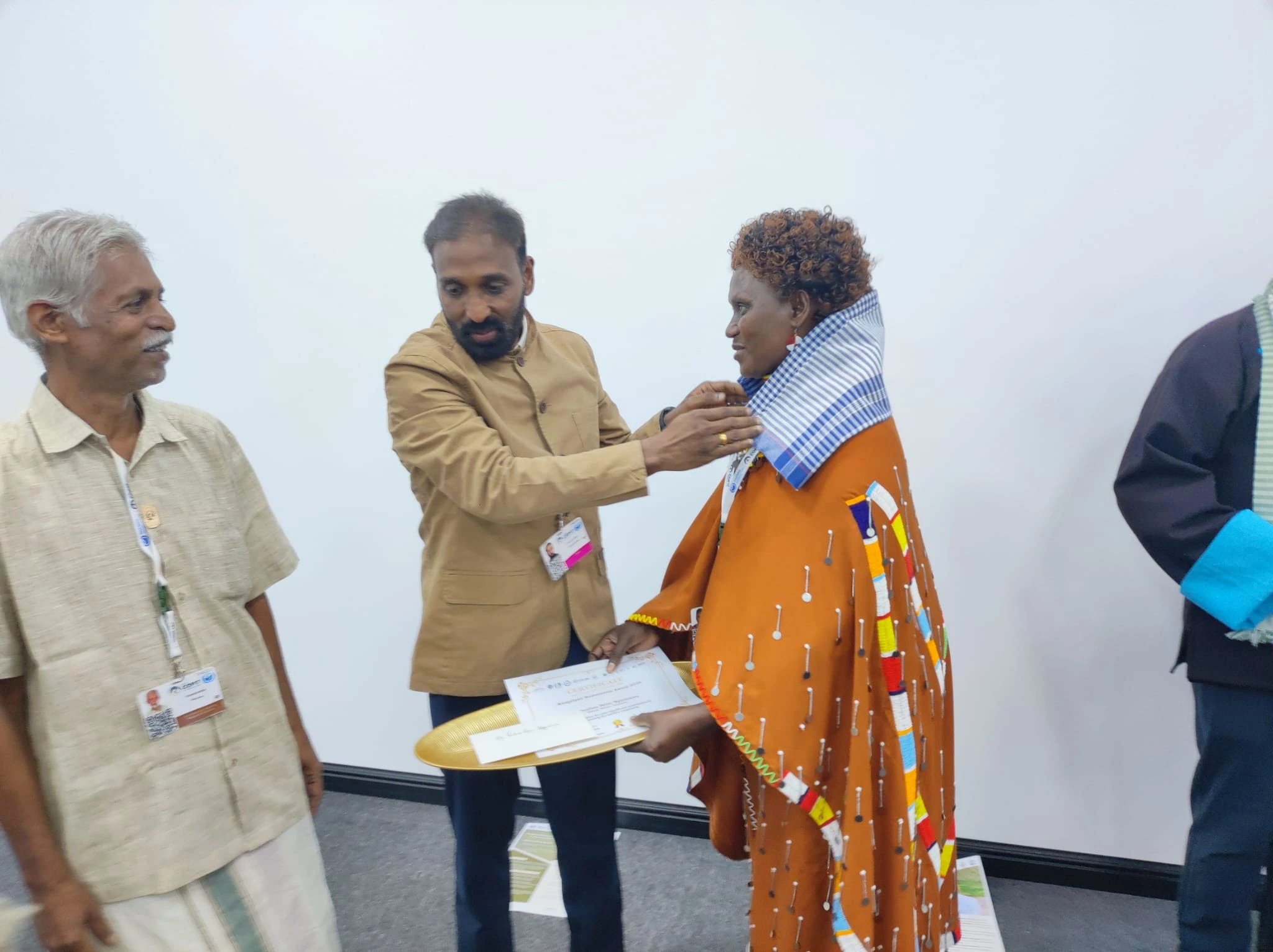 A KINNAPA representative receiving the Rangeland Restoration Award 2026 certificate at UNCCD COP17