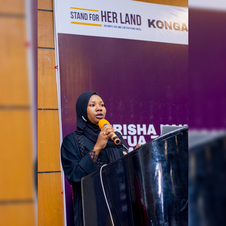 Speaker presenting at the Stand for Her Land Symposium, Dodoma